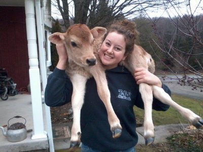 woman holding calf